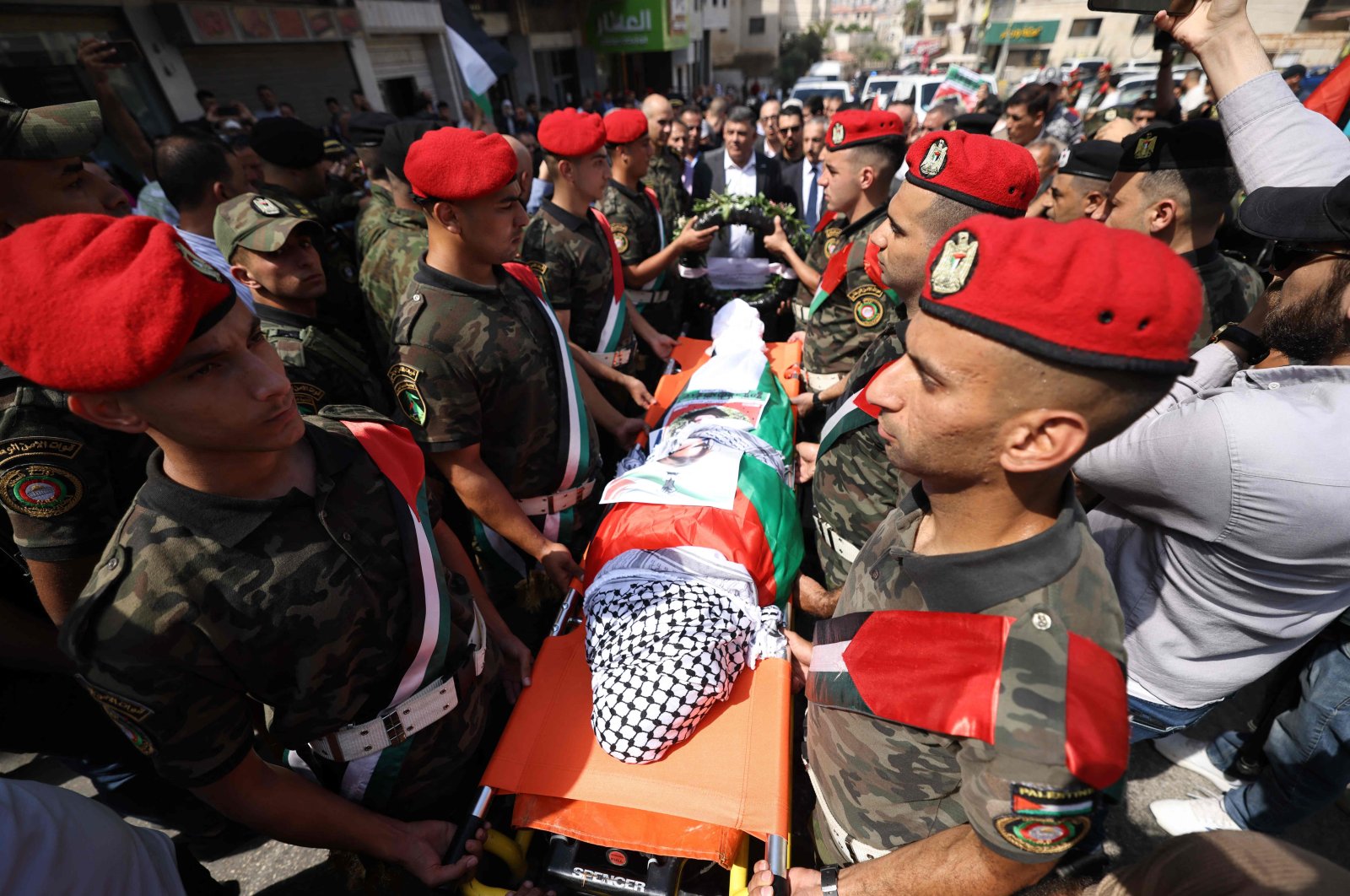 Palestinian security forces carry the body of Aysenur Ezgi Eygi